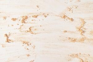 A neutral-colored face powder smeared on the surface, on a light background. Top view, flat position. Copy the location for your text. Powder texture photo