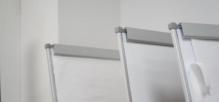 A banner from a row of clean white boards for a business presentation at the stand. Office whiteboard for business training in the office. The concept of the training and seminar. photo