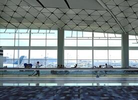 Airport terminal huge glass window with view of airplanes, the gate of departure hall for travelling photo