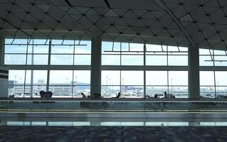 Airport terminal huge glass window with view of airplanes, the gate of departure hall for travelling photo