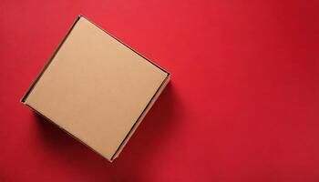 Brown closed cardboard boxes on red backdrop. Craft eco package. Flat lay photo