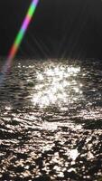 Sparkling sunlight reflecting on rippling water surface creating a mesmerizing and tranquil visual effect, capturing the beauty and serenity of nature video