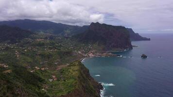 Penha d'Aguia Mountain on Cloudy Day and Ocean. Vereda do Larano. Madeira, Portugal. Aerial View. Orbiting video