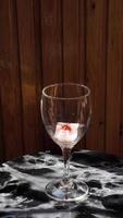 Glass with ice cubes with frozen berries and fruits close-up for a refreshing drink and preservation of seasonal vitamins raspberries, strawberries, cherries, blueberries, mulberries, blackberries video