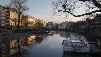 Fyris River with Water Reflection Sunrise in Downtown Uppsala, Sweden, Pan shot video