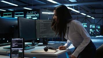 Technician in data center provides technical support to users, troubleshooting issues, close up. Server hub workers carrying out operational technical interventions requested by clients, camera B video