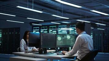 Team of programmers in server hub try to protect hardware from hacker attack stealing sensitive information. Data center cybersecurity division coworkers fight virus during security breach, camera B video