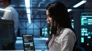 IT specialist in data center providing technical support to customers, troubleshooting issues. Server farm worker carrying out operational technical interventions requested by clients, camera B video