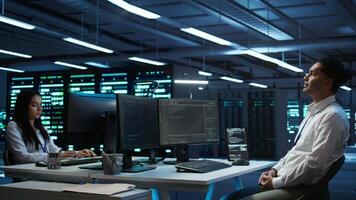 Admin in data center using augmented reality technology to ensure system can handle networking tasks. Server room worker looking at AR visualization hologram, tracking network traffic, camera B video