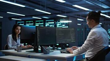 Data center technician responsible for installation and repair of networking equipment solving tasks. IT specialist doing maintenance on server room infrastructure, camera B video