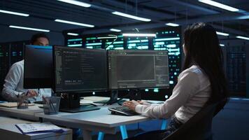 Team of programmers in data center responsible for installation and repair of networking equipment solving tasks. Teamworking colleagues doing maintenance on server room infrastructure, camera B video