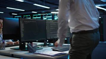 Admin in data center maintaining accurate documentation of infrastructure, configurations and procedures, generating reports. Server room employee doing workspace disaster recovery planning, camera B video