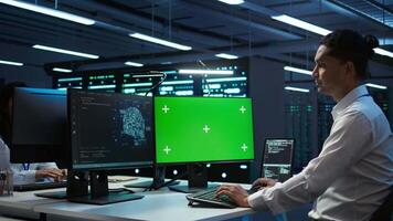 Engineer using AI tech on green screen PC to do checkup in server room. Zoom in of expert in data center using artificial intelligence on mockup computer to process datasets for training, camera B video