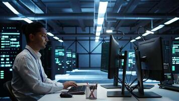 Admin does maintenance on server hub to optimize it for data processing requirements of artificial intelligence workloads. Expert inspects data center used for machine learning, camera B video