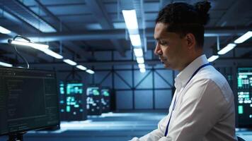 Portrait of smiling data center technician responsible for installation and repair of networking equipment solving tasks. Jolly IT expert doing maintenance on server room infrastructure, camera B video
