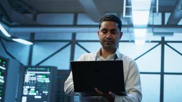 System administrator in data center managing servers, operating systems and software applications. Expert in server hub ensuring networks are secure, up to date, and functioning properly, camera A video