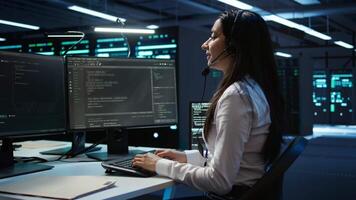 Data center call center agent responsible for providing logistics support to businesses. Worker in server farm establishment oversees infrastructure systems and communicates with engineers, camera B video