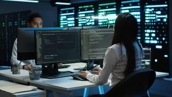 Engineer using augmented reality tech in data center, installing software, troubleshooting issues. IT expert in server hub looks at AR hologram, establishing performance benchmarks, camera A video
