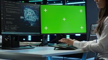 Admin using AI tech on isolated screen PC to do maintenance in server room. Specialist in data center using artificial intelligence on chroma key to process datasets for training, camera A video