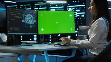 Technician doing checkup on green screen server hub PC to optimize it for data processing requirements of AI. Worker inspects data center used for machine learning using mockup computer, camera A video