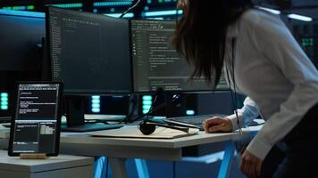 Technician in data center provides technical support to users, troubleshooting issues, close up. Server hub workers carrying out operational technical interventions requested by clients, camera A video