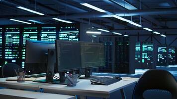 Data center business with networking systems installed used for managing mainframes. Code running on computers in futuristic server room used for overseeing equipment, dolly in shot video