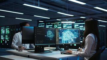 Technicians coworkers using AI tech on computer to do checkup in server room. Teamworking colleagues in data center using artificial intelligence technology to process datasets for training, camera B video