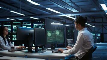 Computer scientists in server room protect hardware from hacker attack stealing sensitive information. Data center cybersecurity division teamworking colleagues fighting security breach, camera B video