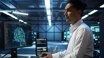 Engineer doing checkup on server hub to optimize it for data processing requirements of AI workloads. Hardworking employee inspects data center used for machine learning, camera B video