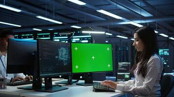 Admin using AI tech on isolated screen PC to do maintenance in server room. Specialist in data center using artificial intelligence on chroma key to process datasets for training, camera B video