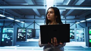 System administrator in high tech data center managing and maintaining databases, ensuring data integrity, security and availability. Manager overseeing server room, upgrading supercomputers systems video