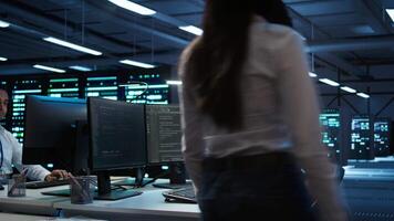 Data center network engineer designing, implementing and managing infrastructure to ensure optimal performance and reliability. IT expert in server room coding on computer, camera B video
