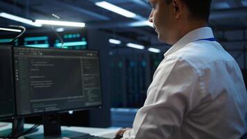 Computer scientist overseeing data center, making improvements and updates to ensure system can handle networking tasks. Close up of woman in server room tracking network traffic, camera B video