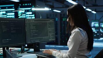 Portrait of smiling engineer overseeing data center, making improvements and updates to ensure system can handle networking tasks. Upbeat server room worker tracking network traffic, camera A video