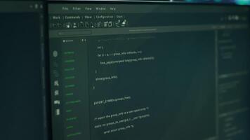 Close up of lines of code running on computer display in modern data center, monitoring security threats. PC software open on monitor used by server hub employees ensuring compliance with regulations video