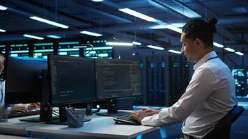 Portrait of upbeat admin in data center managing servers, operating systems and software programs. Joyous specialist in server hub ensuring networks are secure and functioning properly, camera B video