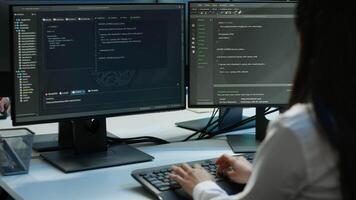 Software developer in data center ensuring system can handle networking tasks. IT professional in server room tracking network traffic with PC, making improvements, camera A video