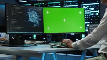 Engineer using AI tech on green screen PC to do checkup in server room. Zoom in of expert in data center using artificial intelligence on mockup computer to process datasets for training, camera A video
