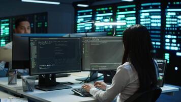 Team of programmers in data center responsible for installation and repair of networking equipment solving tasks. Teamworking colleagues doing maintenance on server room infrastructure, camera A video