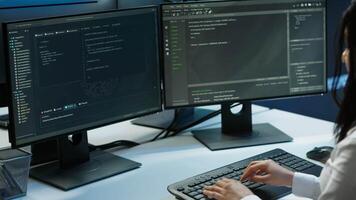 Computer scientist in data center monitoring security threats using PC, implementing cybersecurity measures. Server farm employee ensuring compliance with regulations, camera A video