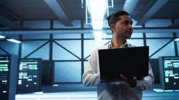 System administrator in data center managing servers, operating systems and software applications. Expert in server hub ensuring networks are secure, up to date, and functioning properly, camera B video