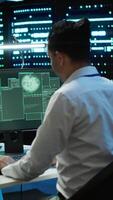 Vertical Team of programmers in server hub try to protect hardware from hacker attack stealing sensitive information. Data center cybersecurity division coworkers fight virus during security breach, camera A video