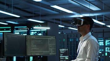 Engineer wearing VR headset in data center installing software on computer, troubleshooting issues. IT expert in server hub using virtual reality tech, establishing performance benchmarks, camera A video