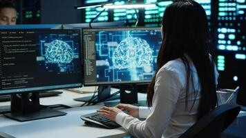 Technicians coworkers using AI tech on computer to do checkup in server room. Teamworking colleagues in data center using artificial intelligence technology to process datasets for training, camera A video