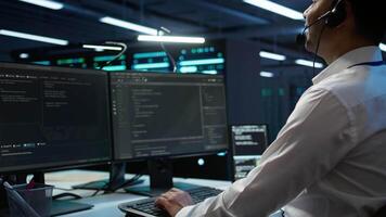 Data center agent providing logistics support in workspace, overseeing equipment rackmounts. Close up shot of server hub staff member communicating with repairmen, camera B video