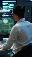 Vertical Team of technicians in server hub alerted by hacker passing firewall and stealing sensitive data. Coworkers panicking after seeing security breach notification on PC in data center workspace, camera A video