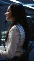 Vertical Data center call center agent responsible for providing logistics support to businesses. Worker in server farm establishment oversees infrastructure systems and communicates with engineers, camera B video