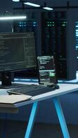 Vertical Person with paraplegia helped by coworker in data center to arrive at desk, coding on PC. Woman in wheelchair doing maintenance on server room infrastructure rackmounts, camera A video