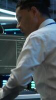 Vertical Admin in data center maintaining accurate documentation of infrastructure, configurations and procedures, generating reports. Server room employee doing workspace disaster recovery planning, camera A video