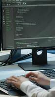 Vertical Programmer in data center typing on computer keyboard, ensuring system can handle networking tasks. IT specialist in server farm tracking network traffic with PC, camera A video